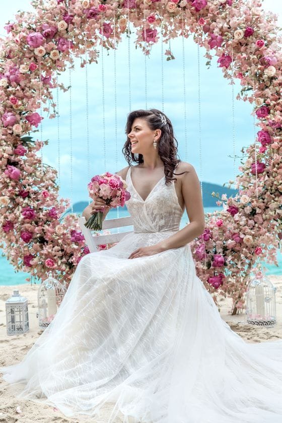 Wedding dress rental Phuket - bride in elegant white gown under floral arch